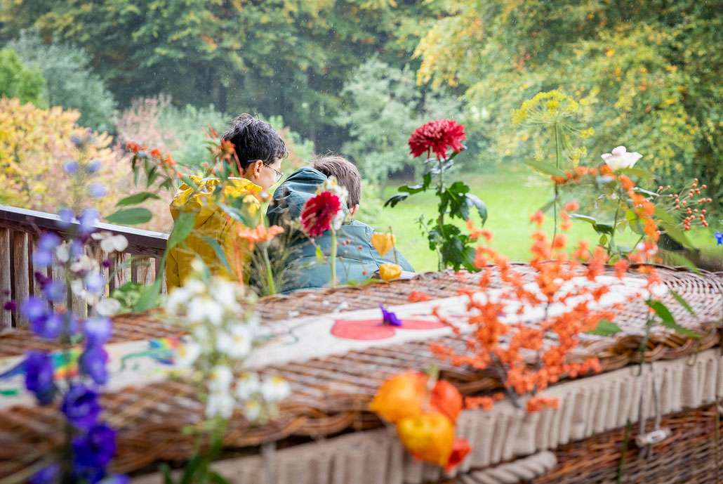 Kinderen bij een mand met bloemenband.